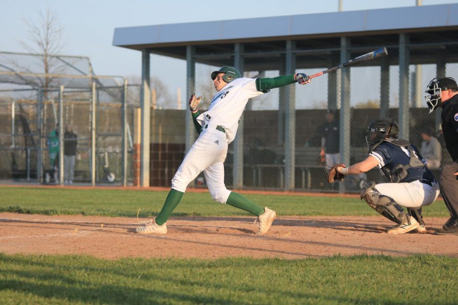 In full swing, junior Caden Hacker bats to keep the JV team undefeated.