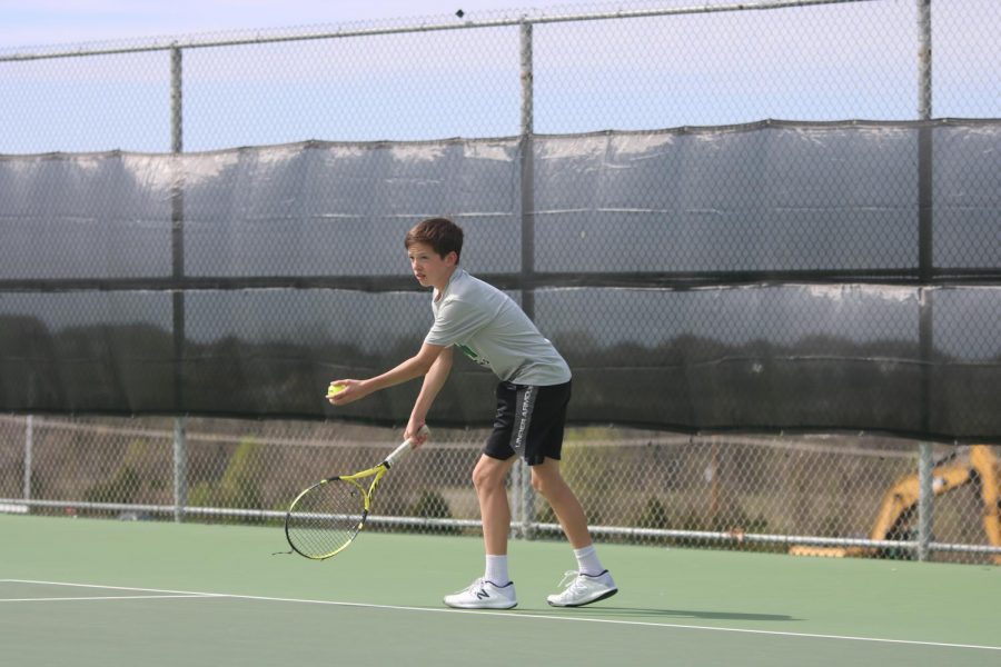 Freshman Emmett Wirth has the ball in hand as he prepares to serve.