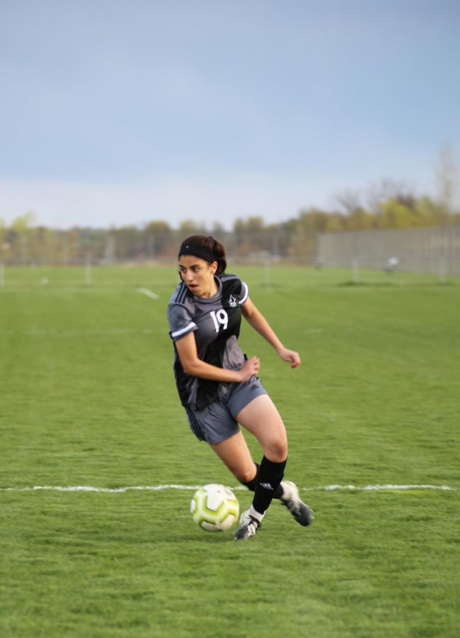 Concentrated on the game, freshman Mellek Ibrahim looks to pass. The girls varsity soccer team won 4-0 against Aquinas on April 13.  