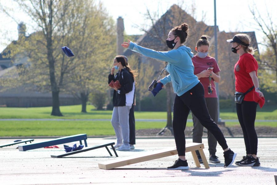 Looking ahead, junior Sutton Cotsworth lets go of her cornhole bag at Cornhole for a Cure on April 24, 2021. Participants were encouraged to donate to help raise money for the Oncology fund at Children’s Mercy. 