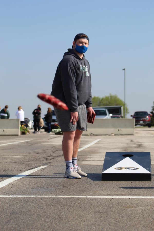 Eyes on the bag, junior Andrew Farrell watches his cornhole bag land on the board at Cornhole for a Cure on April 24, 2021. Farrell competed with senior Hayden Porter as his partner. 
