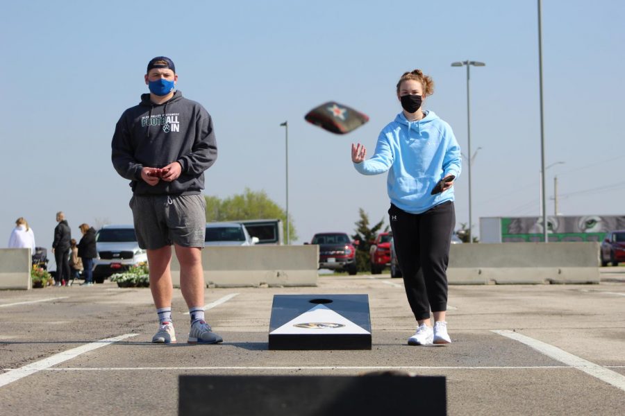 After releasing her cornhole bag, junior Abby Augustine watches to see where it lands at Cornhole for a Cure on April 24, 2021. Augustine was partnered with junior Molly Heidrick. 