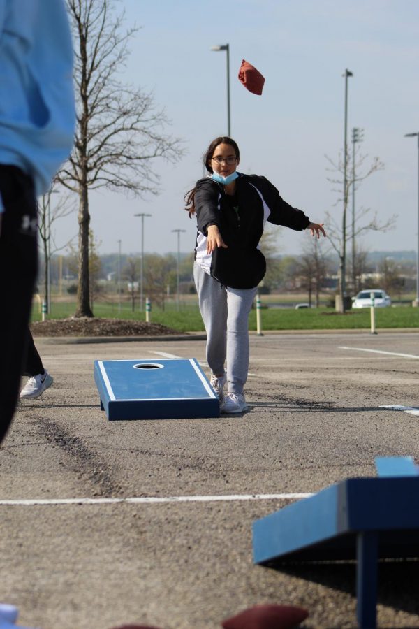 Eyes on the board, junior Molly Heidrick frees the cornhole bag at Cornhole for a Cure on April 24, 2021. Heidrick was a part of Wolf Pack Crew as well as a participant in Cornhole for a Cure.