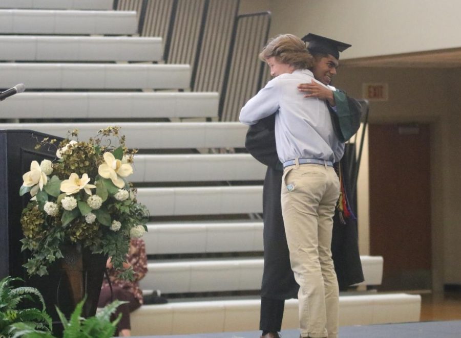 Handing off the keys to the class, senior Karthik Sathish and junior Josh Peterson bro hug on stage at class day on May 21.