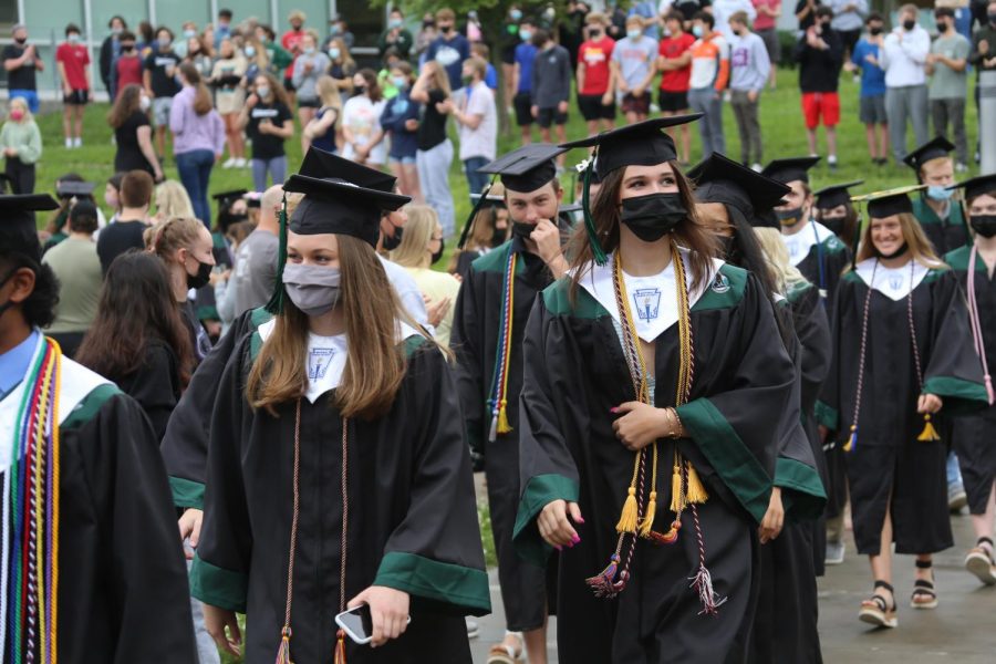 Making their way to the gym, seniors Kate Sawaya and Alex Swanson walk through the courtyard on Class Day.