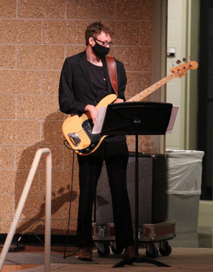 Focused on the music, senior Brayden Silliman plays the electric guitar. The jazz band accompanied the choir on May 4. 