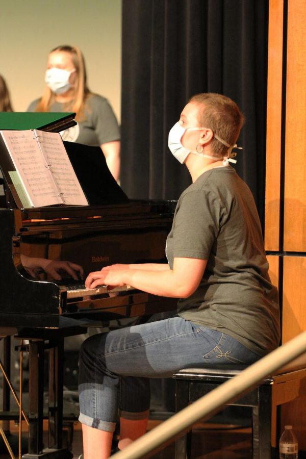 Hands on the keys, junior Karina Allen accompanies the choir on the piano.  