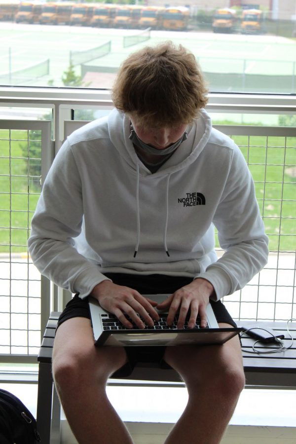 Junior Ethan Levine works on his final project in the hallway.
