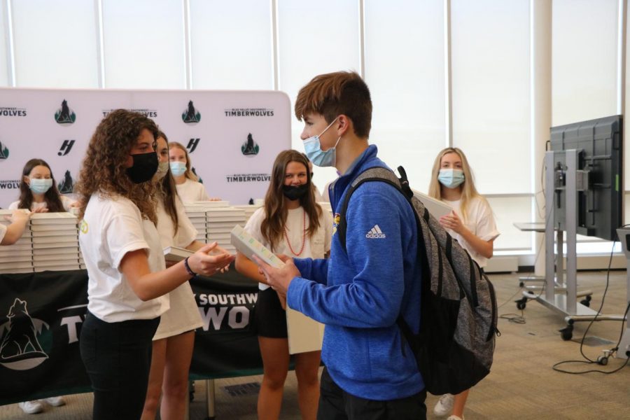 On Distribution Day, freshman Jackson Ready gets handed a copy of the yearbook on May 19. 