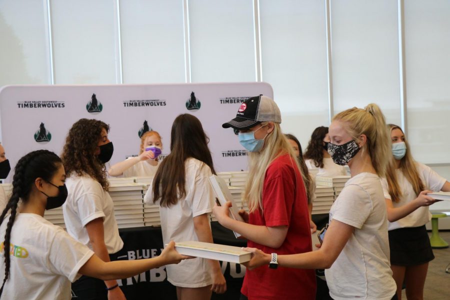 Collecting her yearbook, sophomore Maggie Deppe smiles on Distribution Day on May 19. 