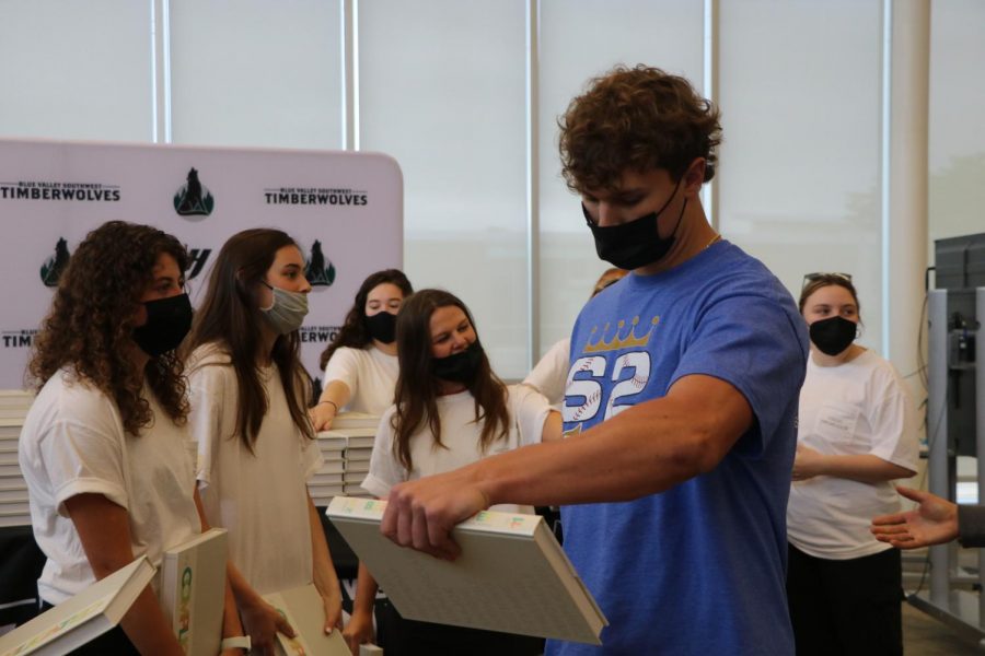 On Distribution Day, junior Chase Brungardt looks down after collecting his yearbook on May 19. 