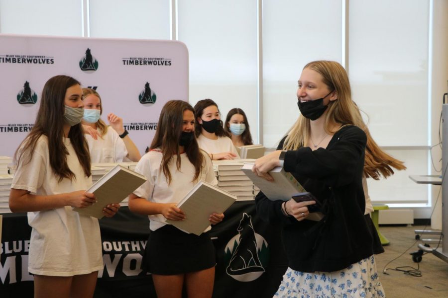 Book in hand, junior Dj Steele laughs after getting her yearbook on Distribution Day on May 19.