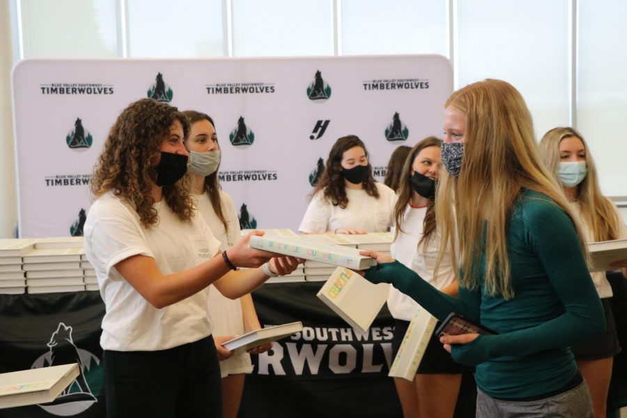 On May 19, senior Leah Goldstein gives a yearbook to freshman Alex Laurie on Distribution Day. 