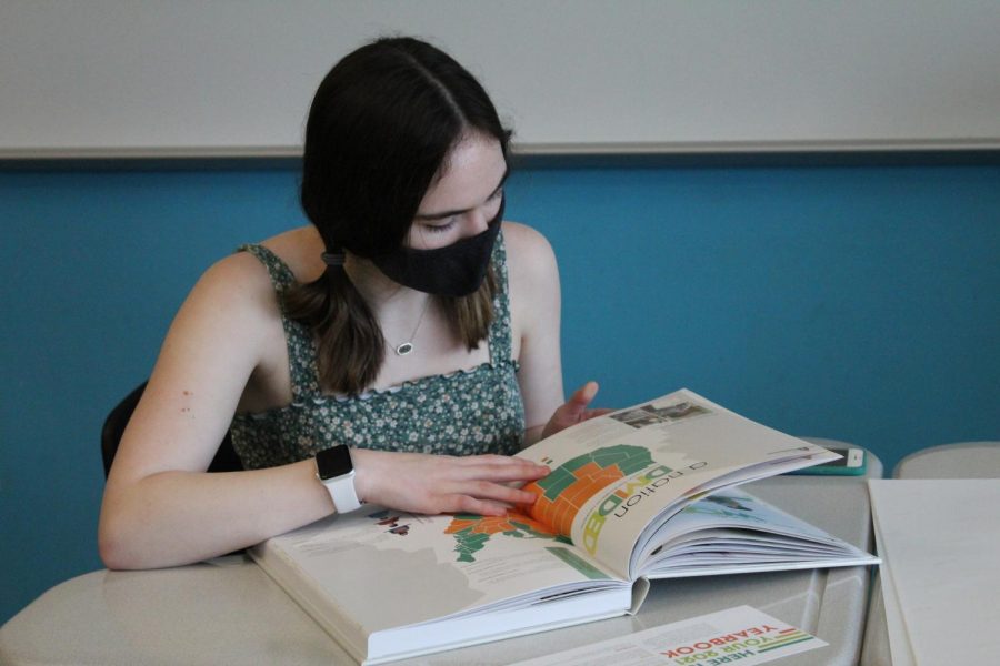 Natalie Robben flips the page as she goes through the yearbook.
