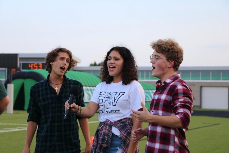 Seniors Jonah West, Kennadie Campbell and Sam Illum sing the National Anthem prior to the start of the game.