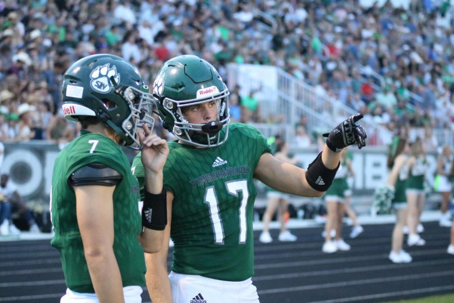 Senior Davis Brogan talks with a teammate during the senior night football game on Sept. 3.