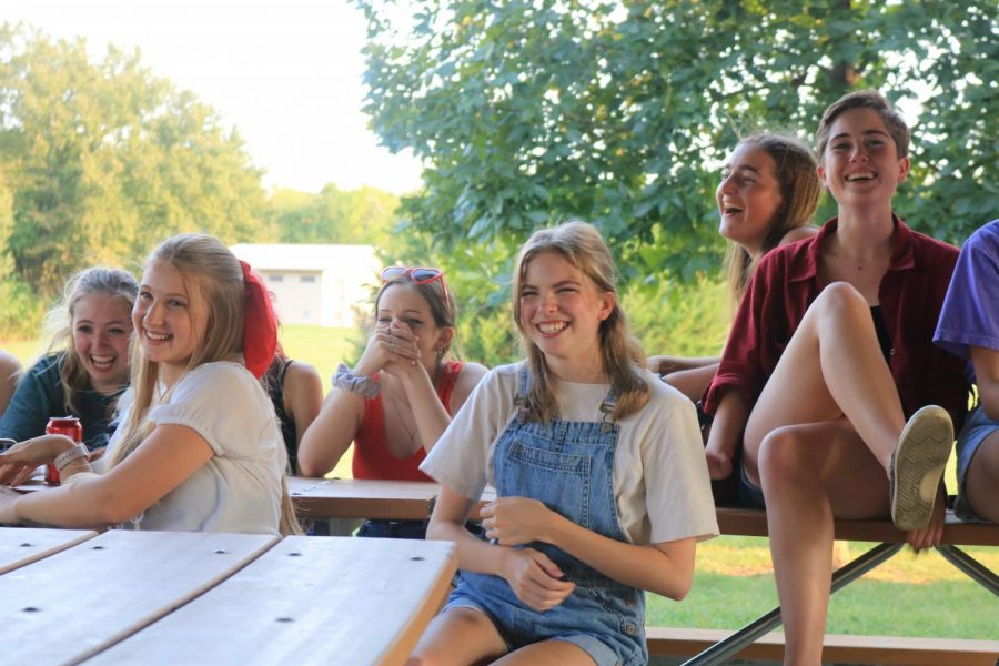 Seniors Kyra Tatge, Sydney Gilman and Kathleen Speer react to the announcement of the Spring Musical, Footloose at the Theater Picnic on Sept. 12.