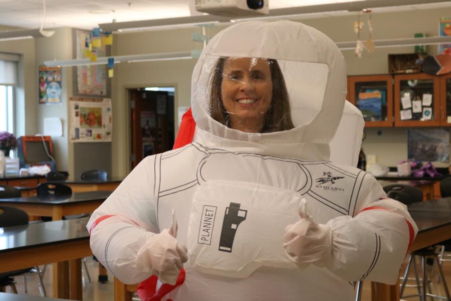 Science teacher Lisa Turney smiles while dressed as an astronaut for halloween. 