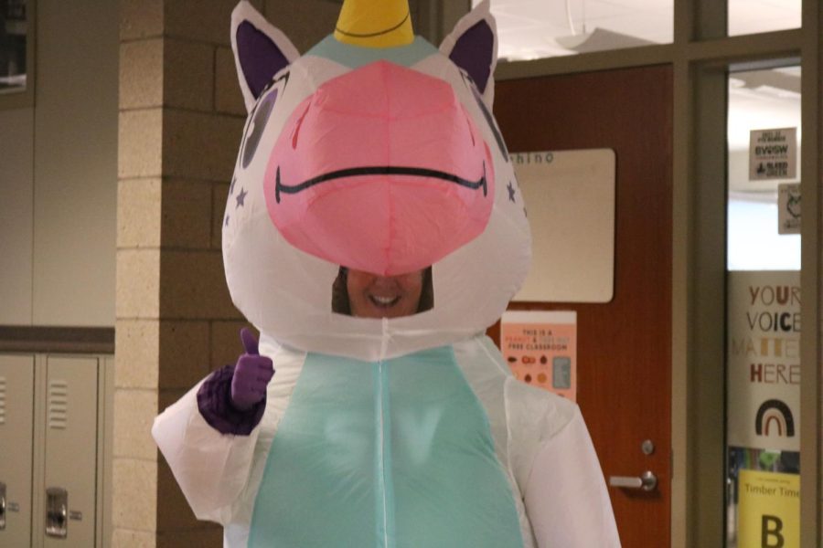 Science teacher Lynn Martens stops to take a photo dressed in her unicorn costume. 
