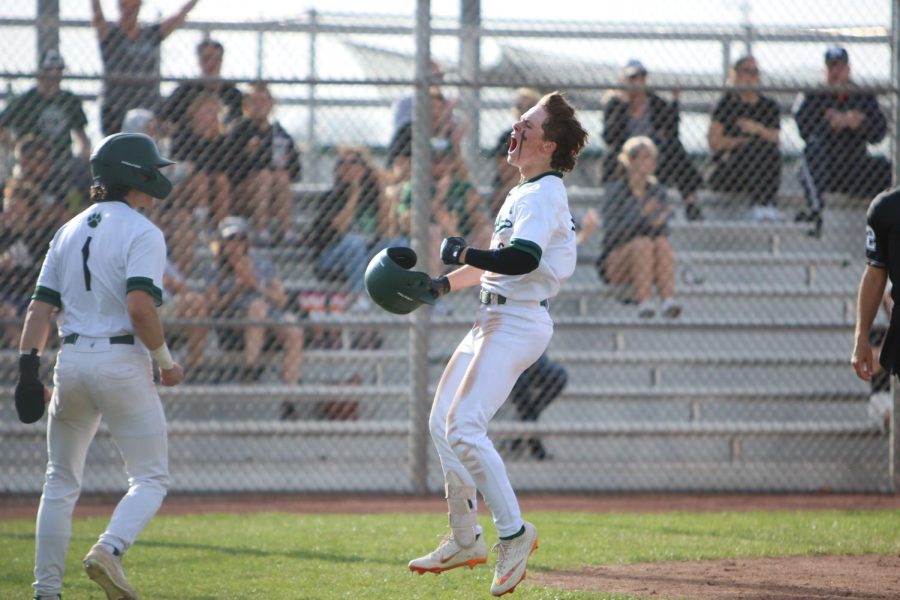 Jumping in celebration, Junior Seth Dandridge comes into home after hitting an HR and 2 RBIS.