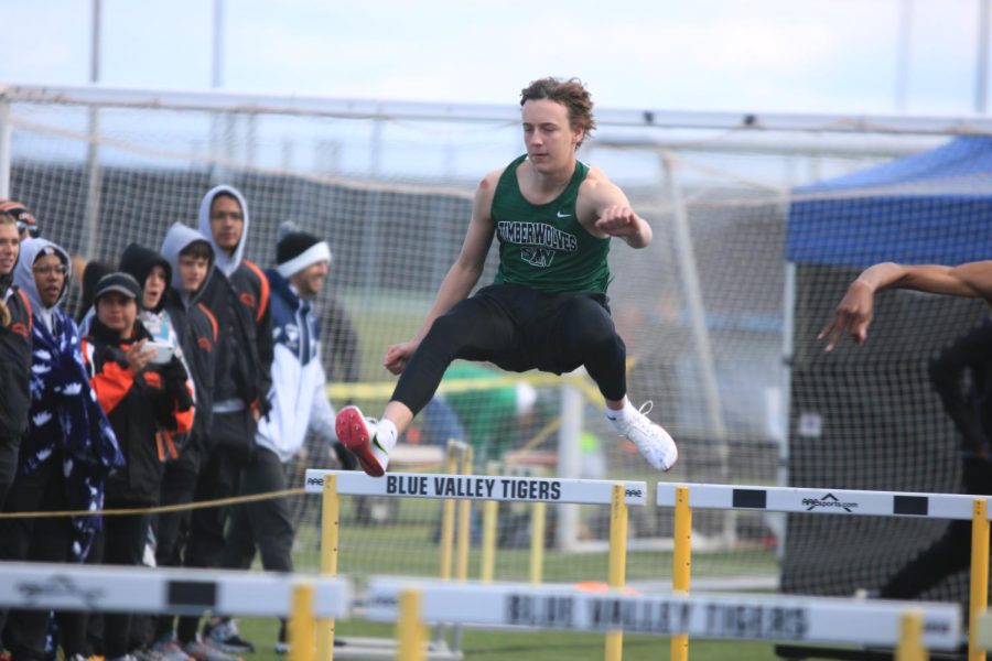 Sophomore Kaleb Tesmer leaps over the hurdles during the Varsity Relays on April 8th