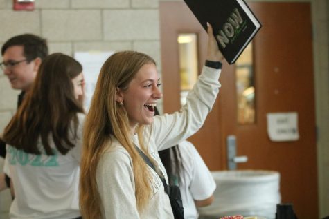 On May 13, Senior Lydia Peterson raises her yearbook in celebration of Distribution Day