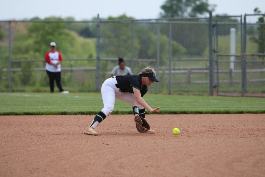 On May 17, senior Emma Payne prepares to ground the ball before throwing it to first base during warm-ups.