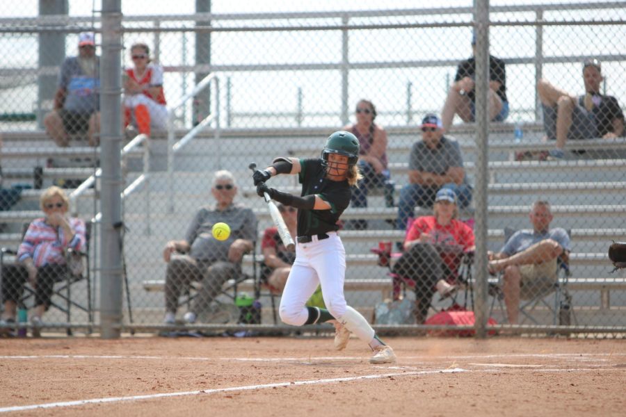 Eyes on the ball, sophomore Bailey Weber hits the ball down third base line during the varsity softball regionals game on May 17.