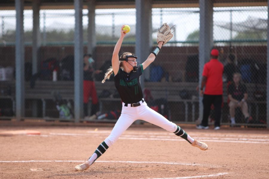 At the varsity softball regionals game against Lansing, senior Sophie Brickman winds up to release a pitch.  