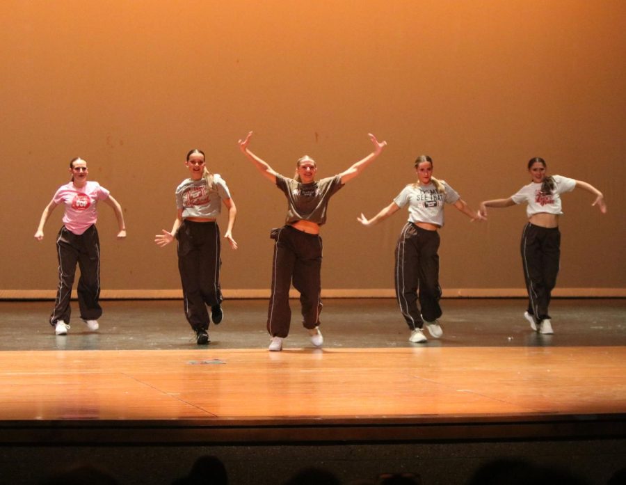 Hands in the air, junior Molly Hoggatt performs in the junior class dance during the showcase on April 7.