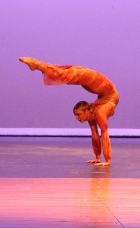 Eyes fixed forward, senior Maggie Deppe displays her flexibility during the spring showcase on April 7.