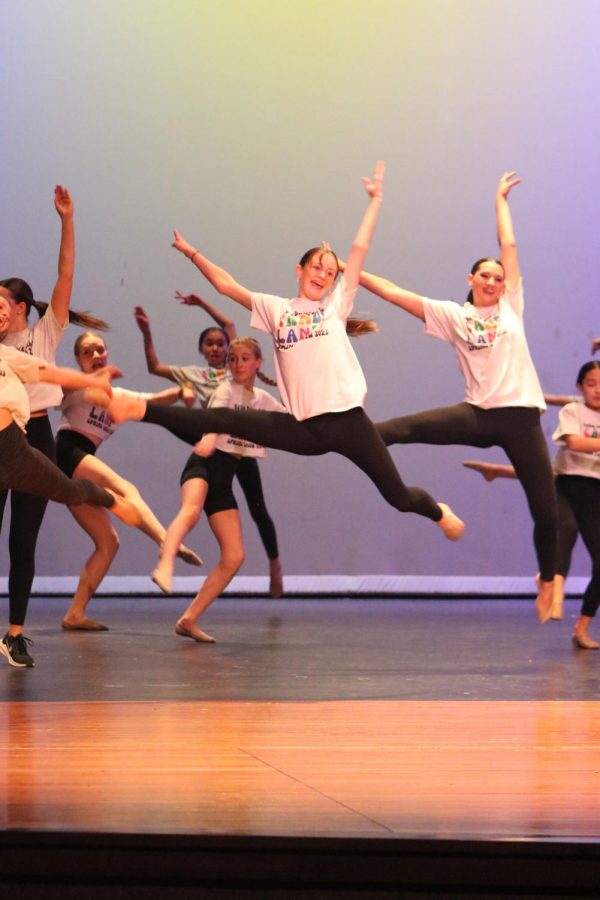 In the air, dance clinic participant displays what she learned during the glitter girls showcase on April 7.