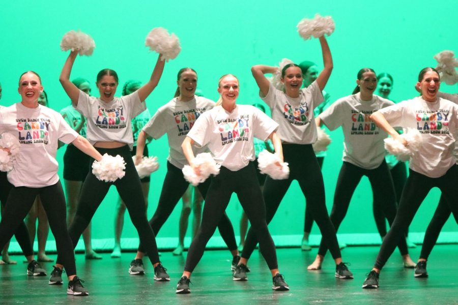 Pom-poms in hand, senior Maggie Deppe dances to the fight song during the spring showcase on April 7.