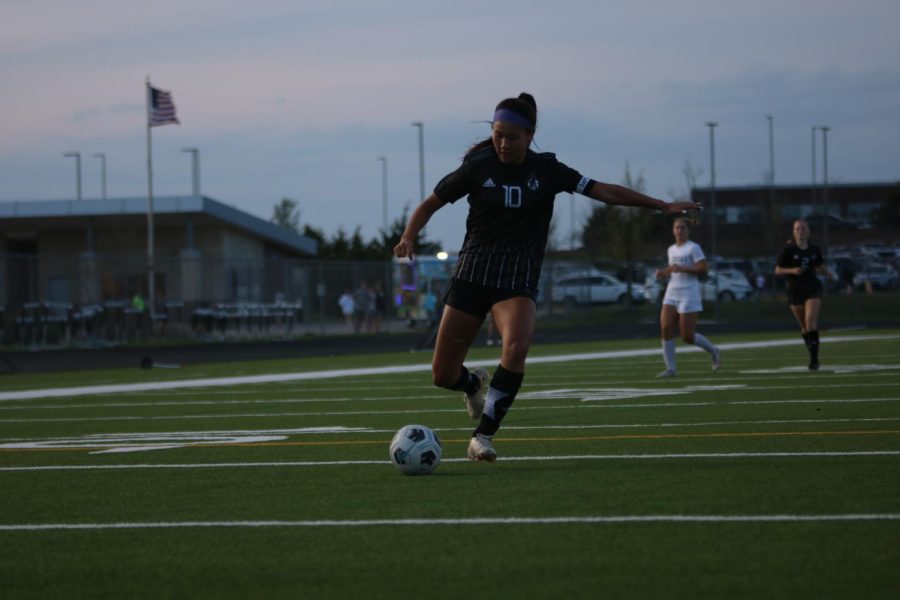 Eyes on the ball, junior Hope Kim loads her leg for a kick. 