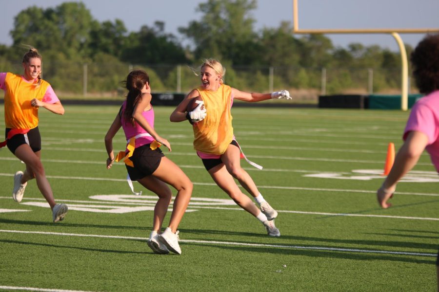 Gloves on, junior Alex Laurie runs the ball during the tournament on May 7.