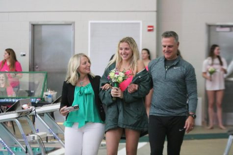 Walking with her parents, Senior Jessica Heise smiles as her favorite hype song My Way by Frank Sinatra plays. 