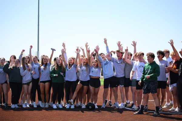 Hands in the air, sophomores celebrate kickball win during field day on April 12. 