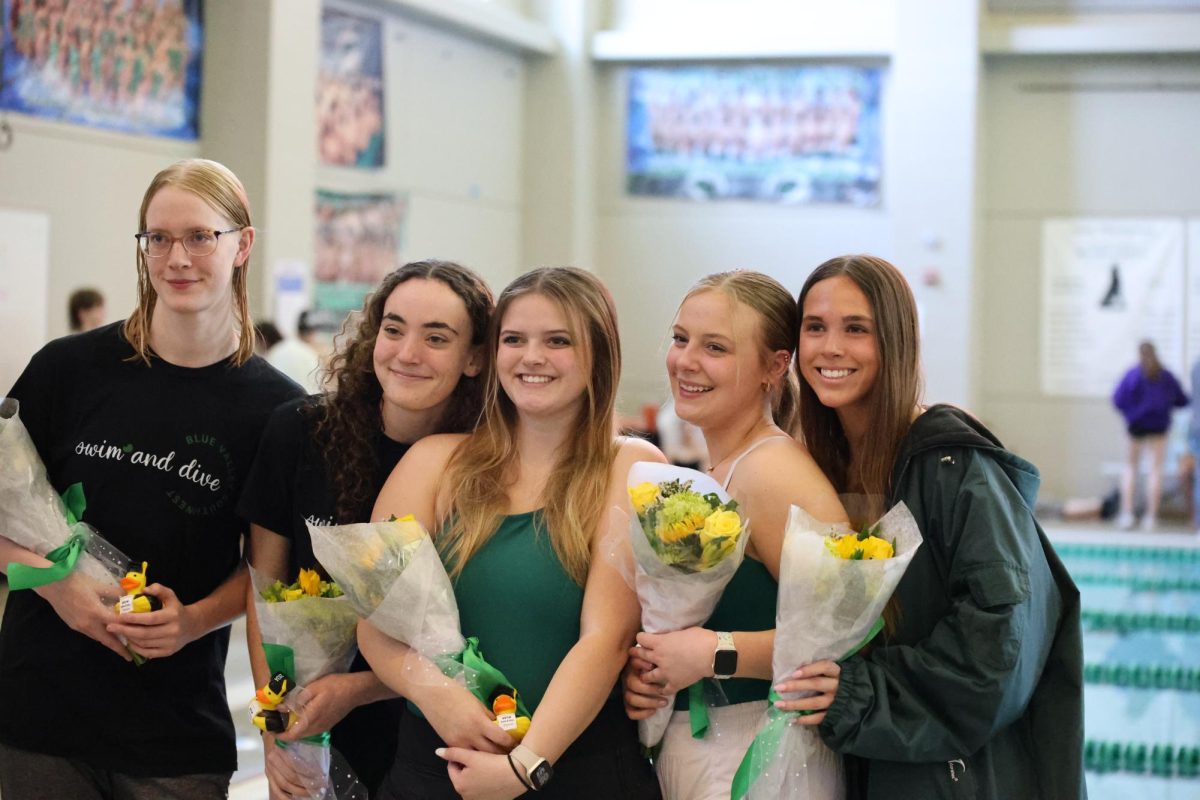 At senior night on April 23 the swim and dive girls posed for a photo after the senior recognition. 