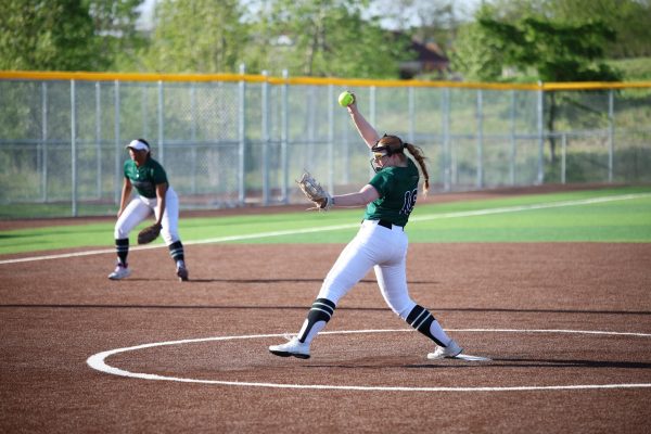 Winding up, senior Meghan Hentschel pitches at the doubleheader against Blue Valley North on April 16. The team was victorious in both games with end scores of 9-5 and 11-5.