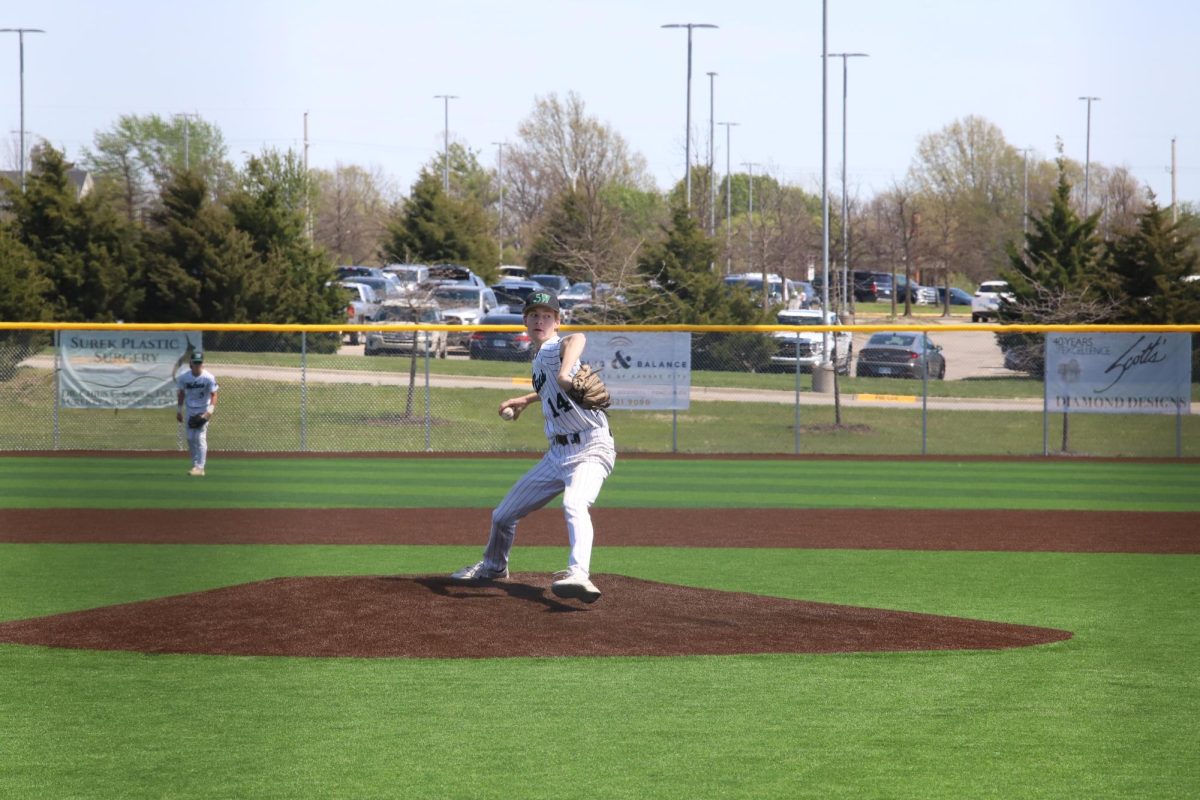 On the mound, senior Sterling Widman pitches the ball to Gardner Edgerton on Apr. 13.