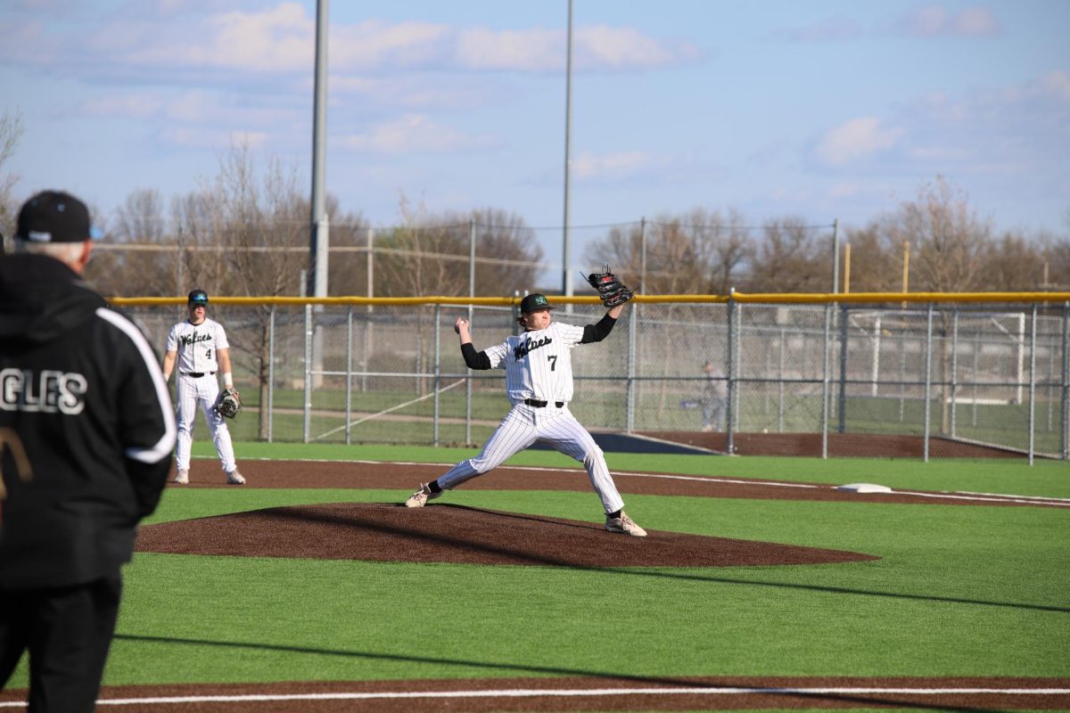 Throw in motion, senior Jason Cooper pitches at varsity baseball game against Blue Valley Northwest on April 2. 