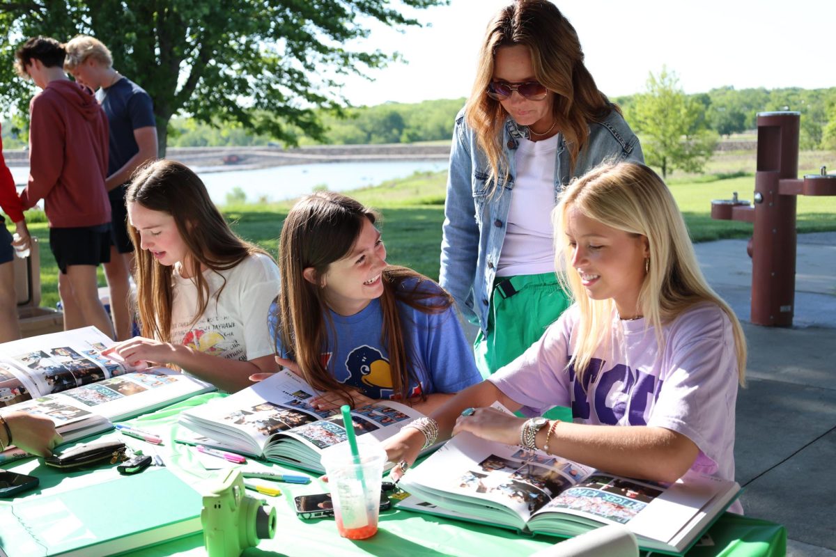 Senior Grace Zimmerman laughs with friends during senior picnic on May 10. 