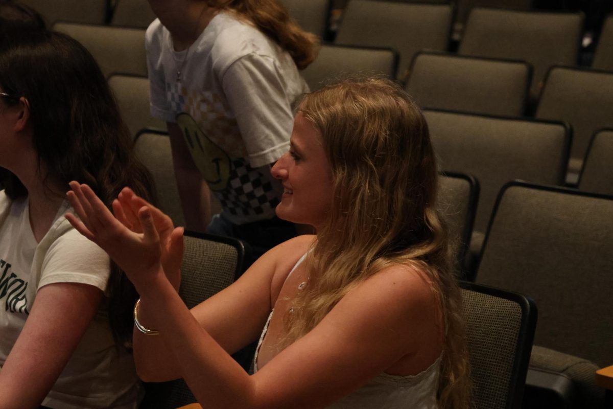 Senior Mia LeFevre cheers in celebration of a Blue Star Award. 