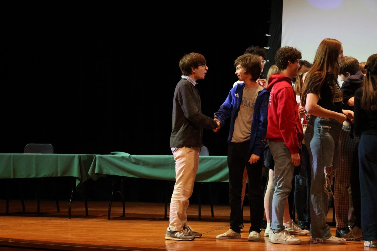 Senior Max Clark and Senior Max Newlin shake hands. 