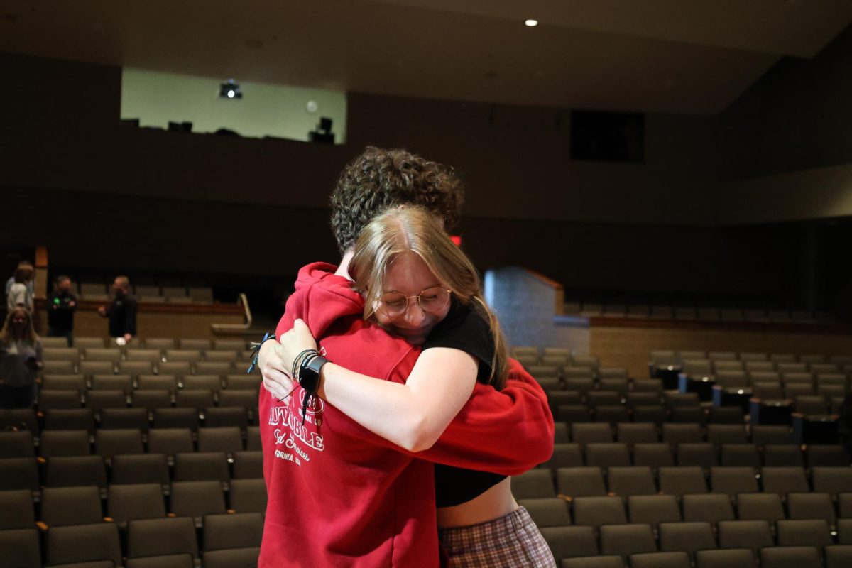 Senior Emily Chipack and senior Cameron Hargrove hug each other. 