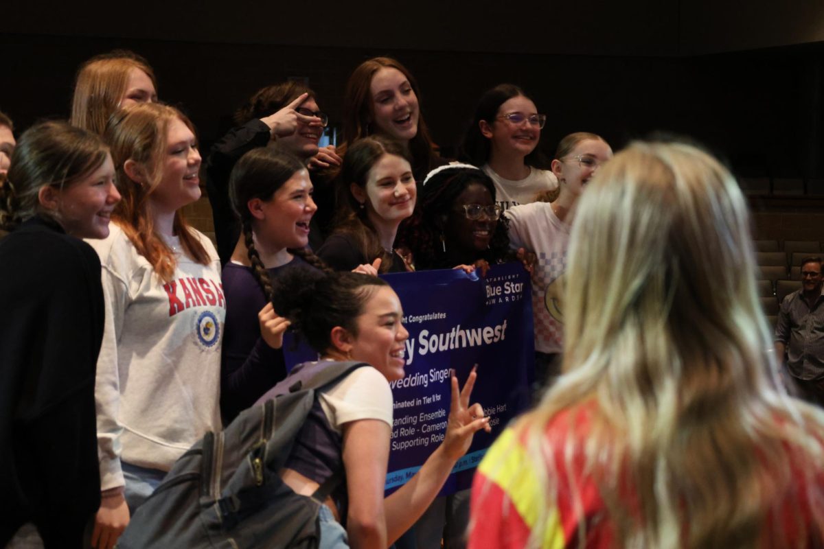The cast poses for a picture. 