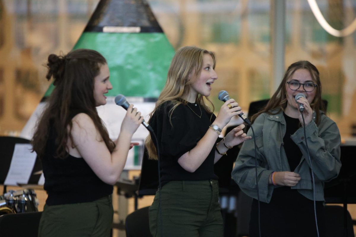 Looking at her team, junior Lizzie Salin sings as a trebalaire for the Jazz Cafe on April 24. 