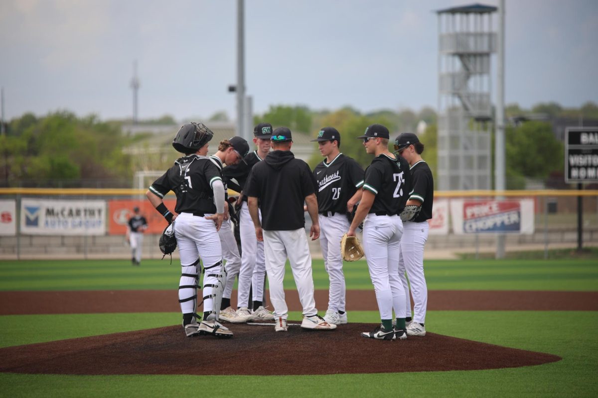 Huddled up, coach Scott Shannon gathers his team up to talk to them.