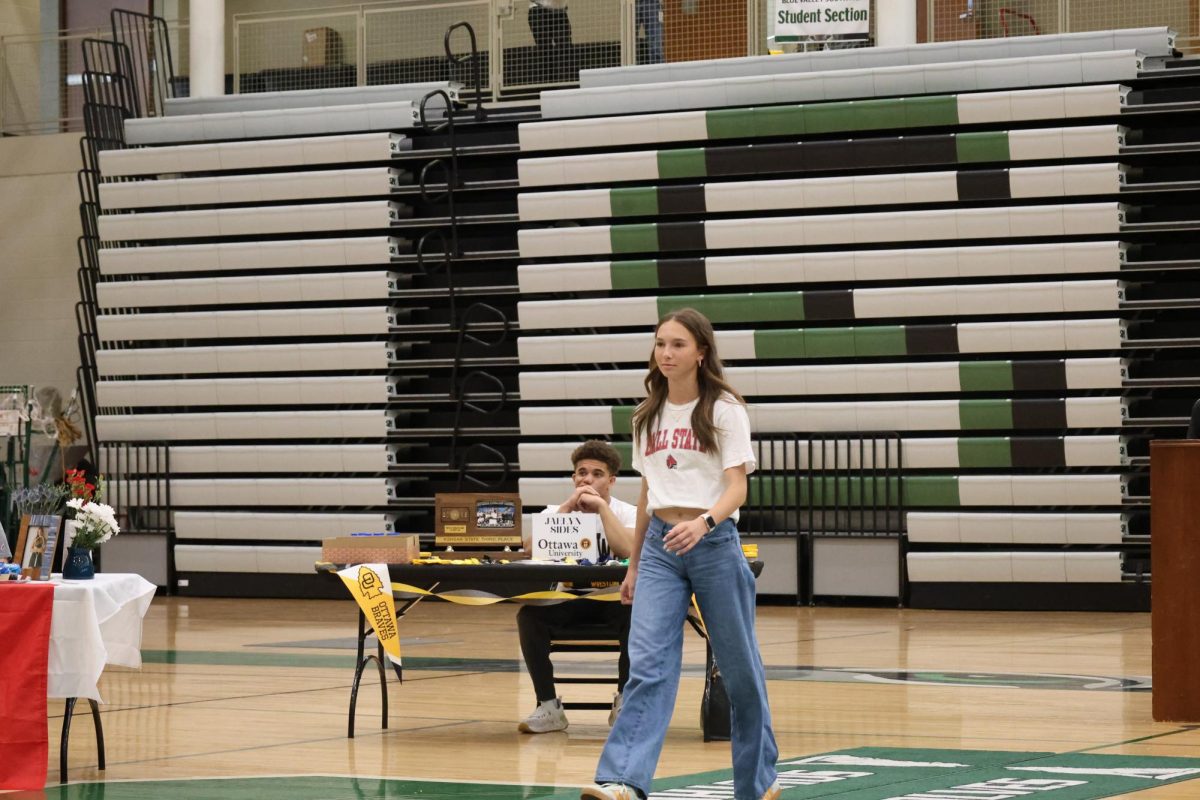 In motion, senior Isabella Ross walks up to the stand
