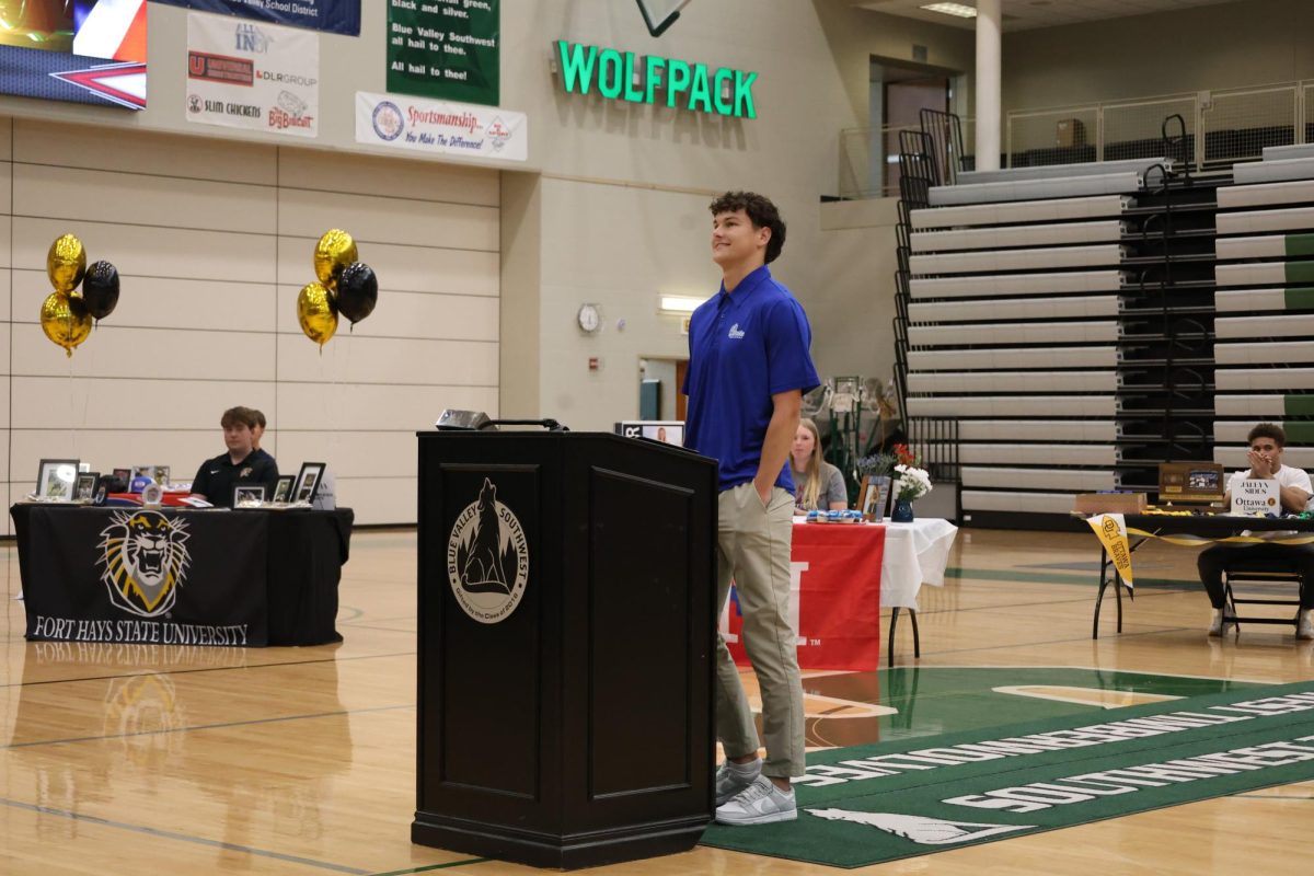 Stand and smile, senior Crew Alvarez smiles to the crowd after signing